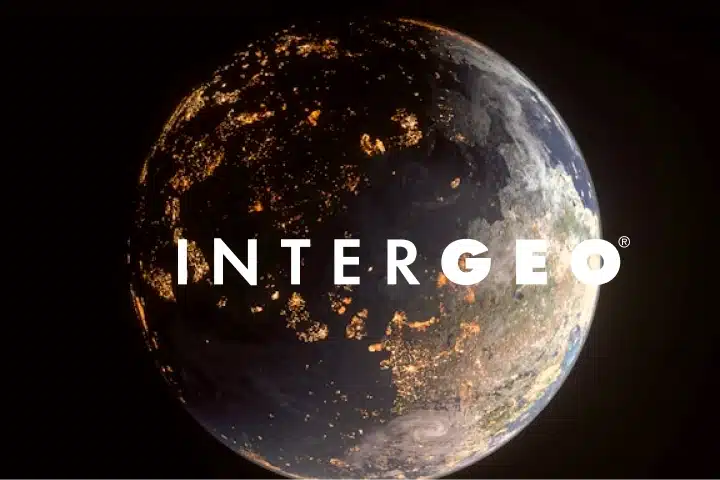 A view of Earth from space at night with city lights visible, overlaid with the word “INTERGEO” in bold white letters across the center, highlighting global events and connectivity.