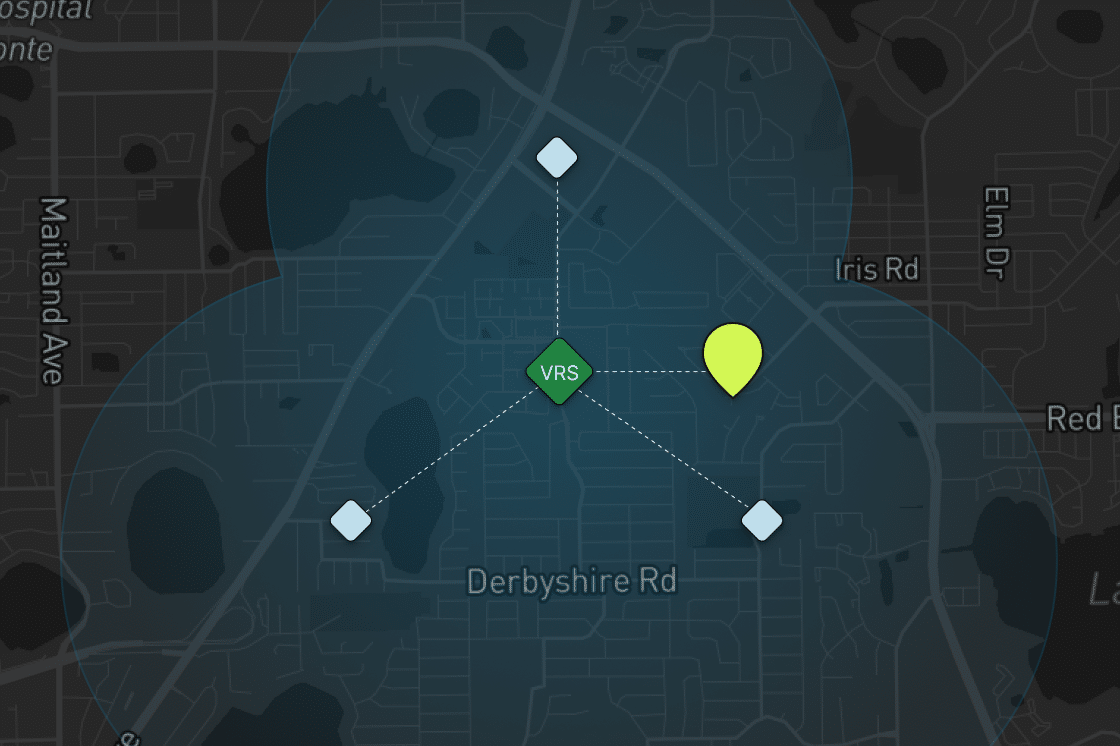 A dark map showing Derbyshire Rd and nearby streets, with blue shaded areas, three blue diamond-shaped nodes linked to a green VRS hexagon at the center, and a yellow-green marker to the right of the center.
