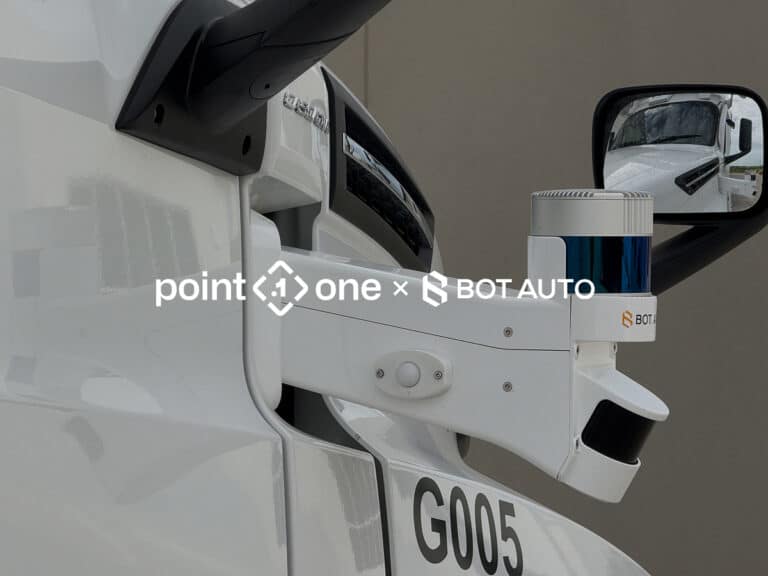 Close-up of a white autonomous vehicle featuring advanced sensors and cameras for precision ag, mounted near the side mirror, with logos for point one and BOT AUTO overlaid on the image.