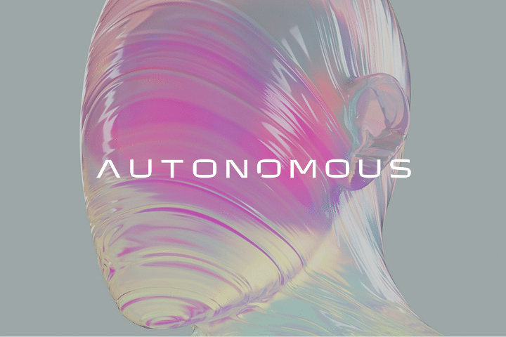 A translucent, abstract human head with swirling pastel colors and the words AUTONOMOUS CONFERENCE in bold white letters centered across the face, set against a plain gray background.
