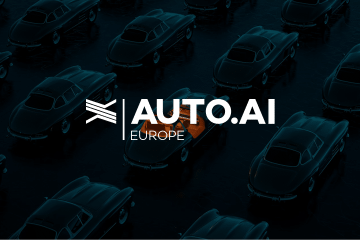 Dark image of vintage cars with one cars interior illuminated in orange. Overlaid white text reads AUTO.AI EUROPE with a stylized logo on the left.