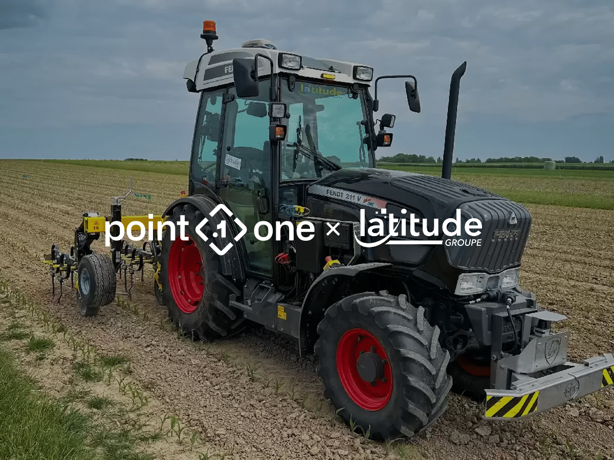 A black tractor with red wheels, showcasing the latest in robotics and autonomous vehicles, works in a field under a cloudy sky. The logos point.one x latitude are overlaid on the image.