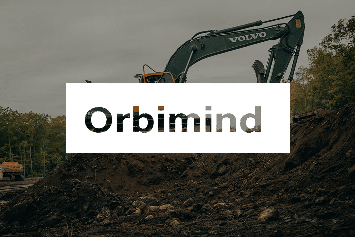 A green Volvo excavator equipped with advanced robotics operates at a construction site with trees in the background. The word Orbimind is overlaid in bold letters across the center of the image, highlighting innovation in off-road autonomy.